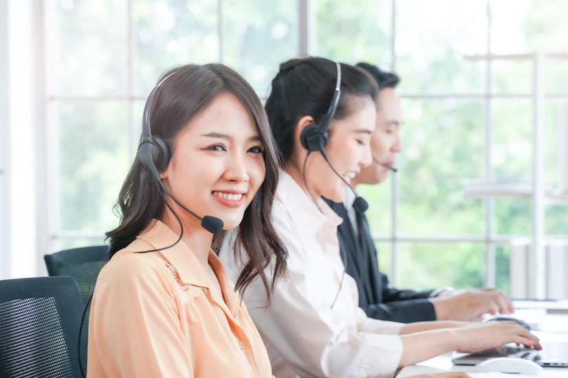 portrait call center worker accompanied by man woman team smiling customer support operator work concept people telephone operator call center customer support 28976 1585