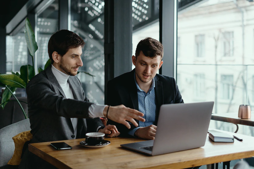 two businessmen pointing laptop screen while discussing 158595 5324