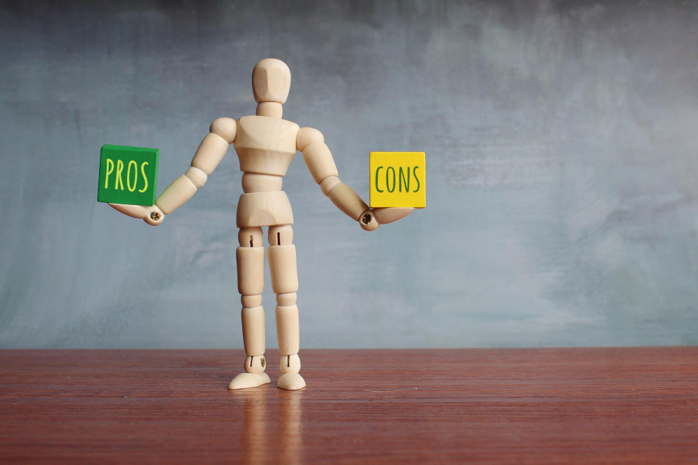 pros cons balance concept wooden human figure balancing wooden cubes with text pros cons